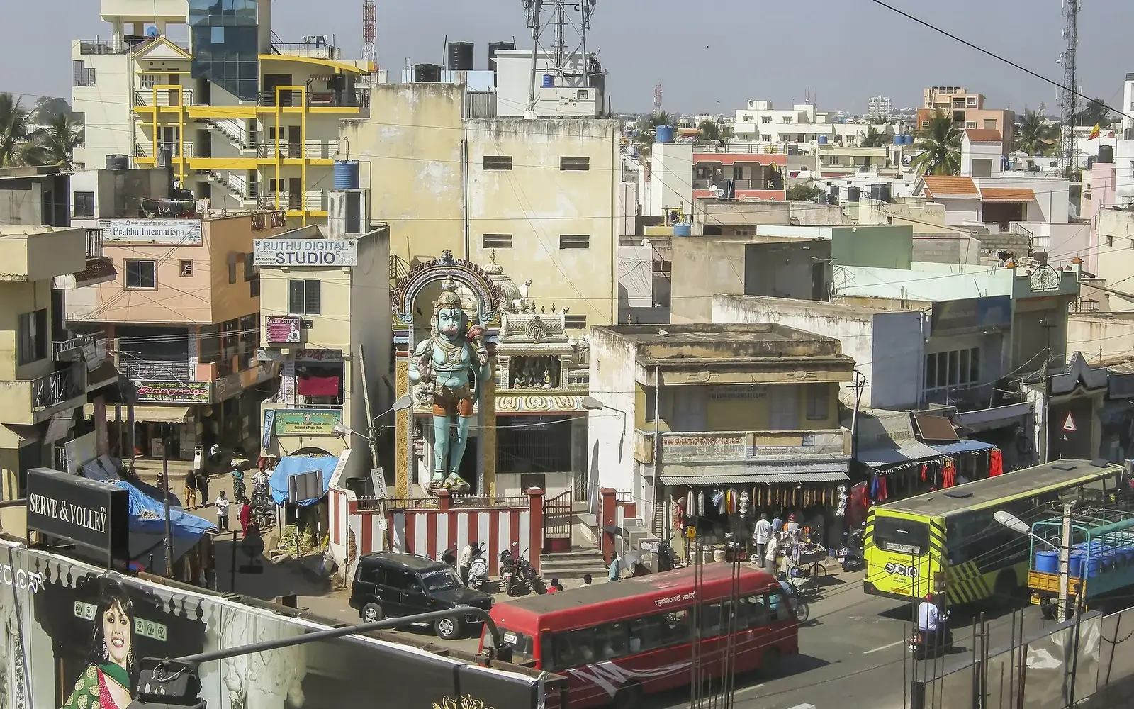 Downtown Bengaluru with traffic and high‑rise buildings under a clear sky