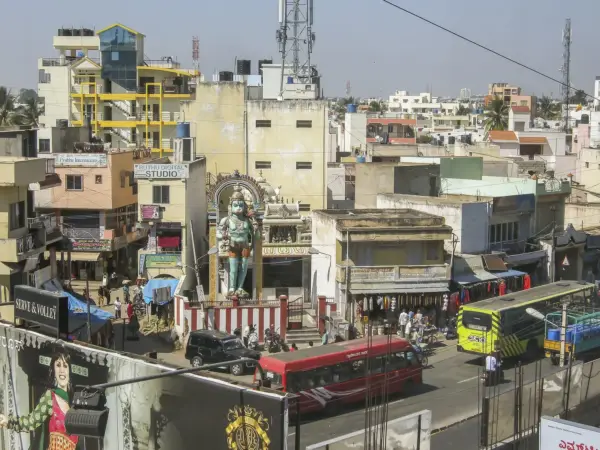 Downtown Bengaluru with traffic and high‑rise buildings under a clear sky