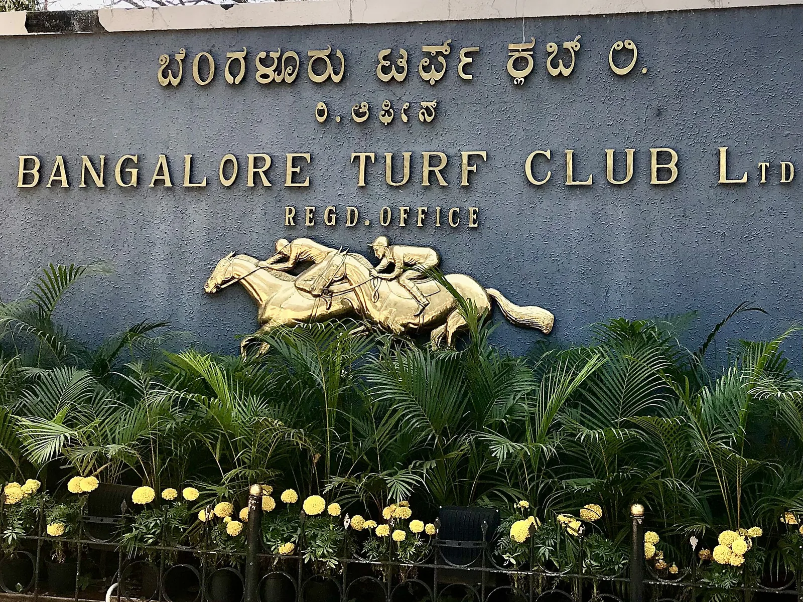 Bangalore Turf Club's grand façade with lush green surroundings