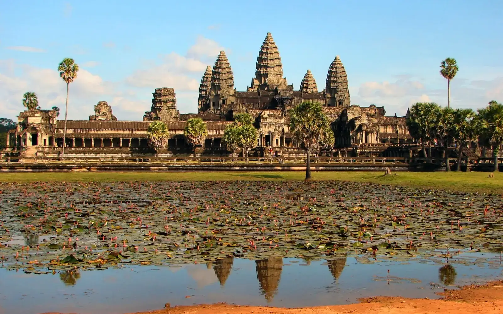 Angkor Wat and its towers reflected in the pond in front of the temple, Siem Reap