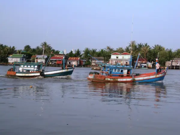 Colourful fishing boats on the river at Kampot