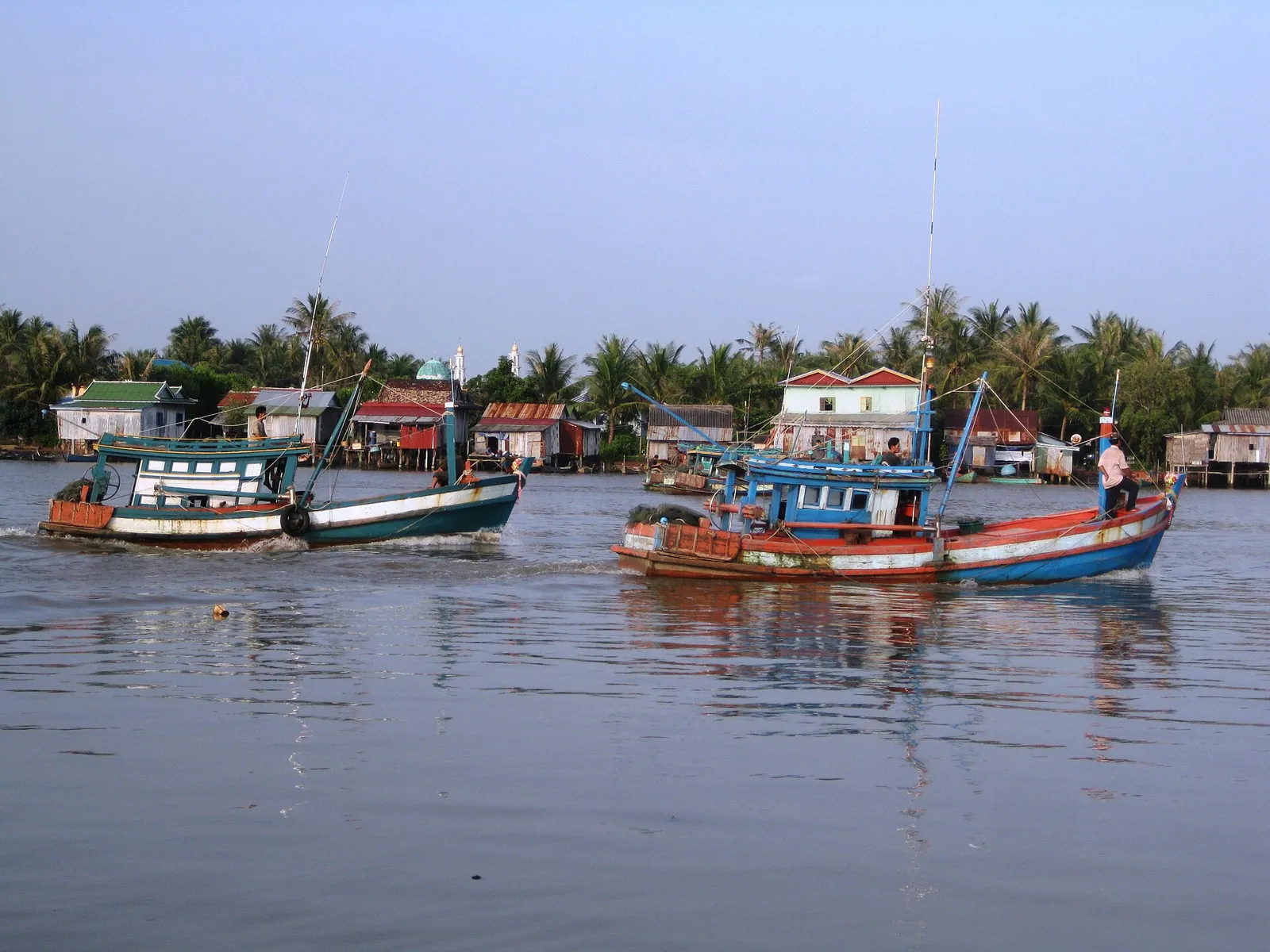 Colourful fishing boats on the river at Kampot