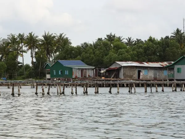 Stilt houses and fishing boats in a fishing village in Stueng Hav district on the Cambodian coast