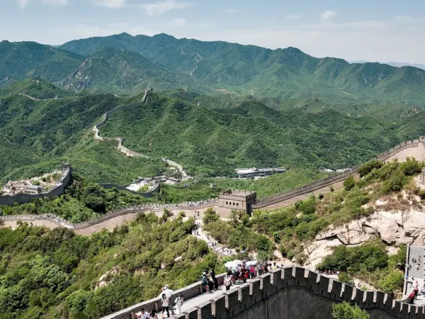 The Badaling section of the Great Wall winding over mountains, with watchtowers and stone steps.