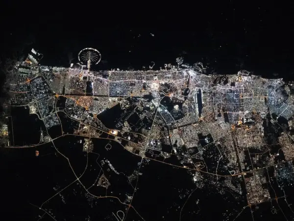Dubai skyline with Palm Jumeirah lit at night from ISS