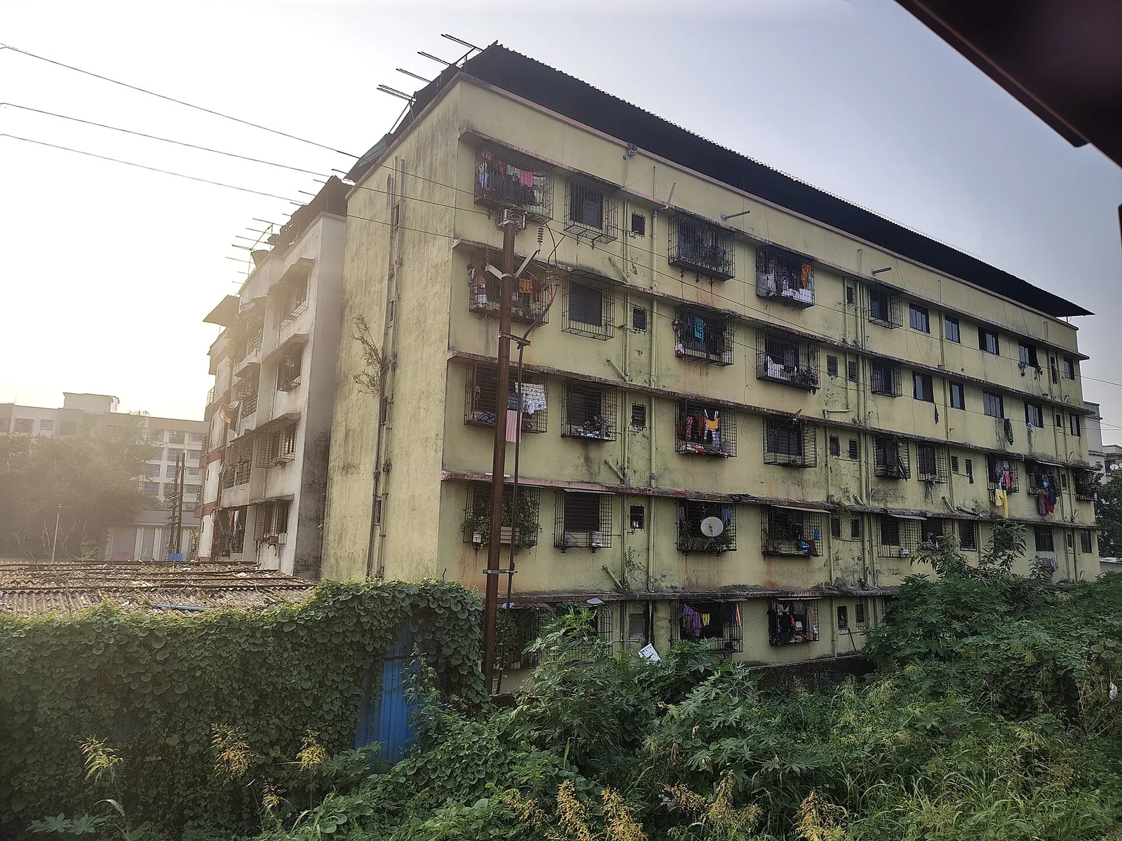 Row of mixed-age commercial buildings lining a busy Mumbai street