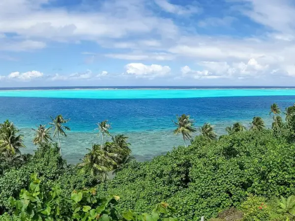 Green hillside and turquoise lagoon on Huahine
