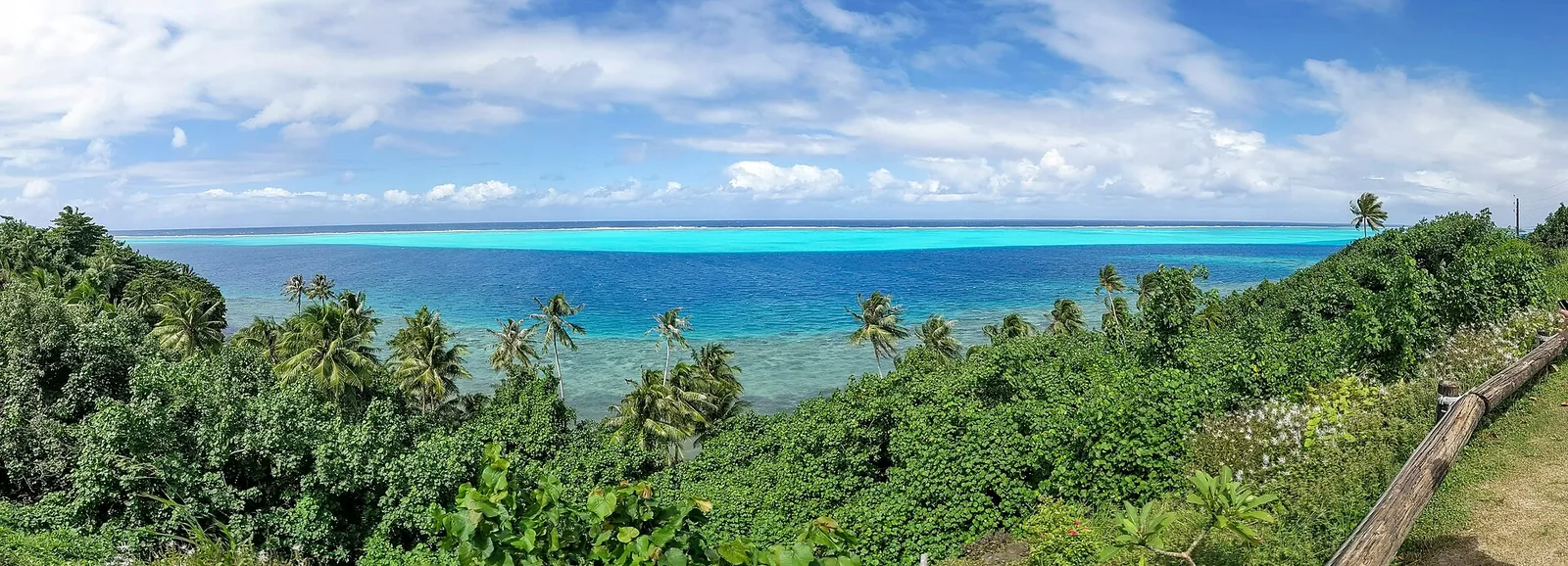 Green hillside and turquoise lagoon on Huahine