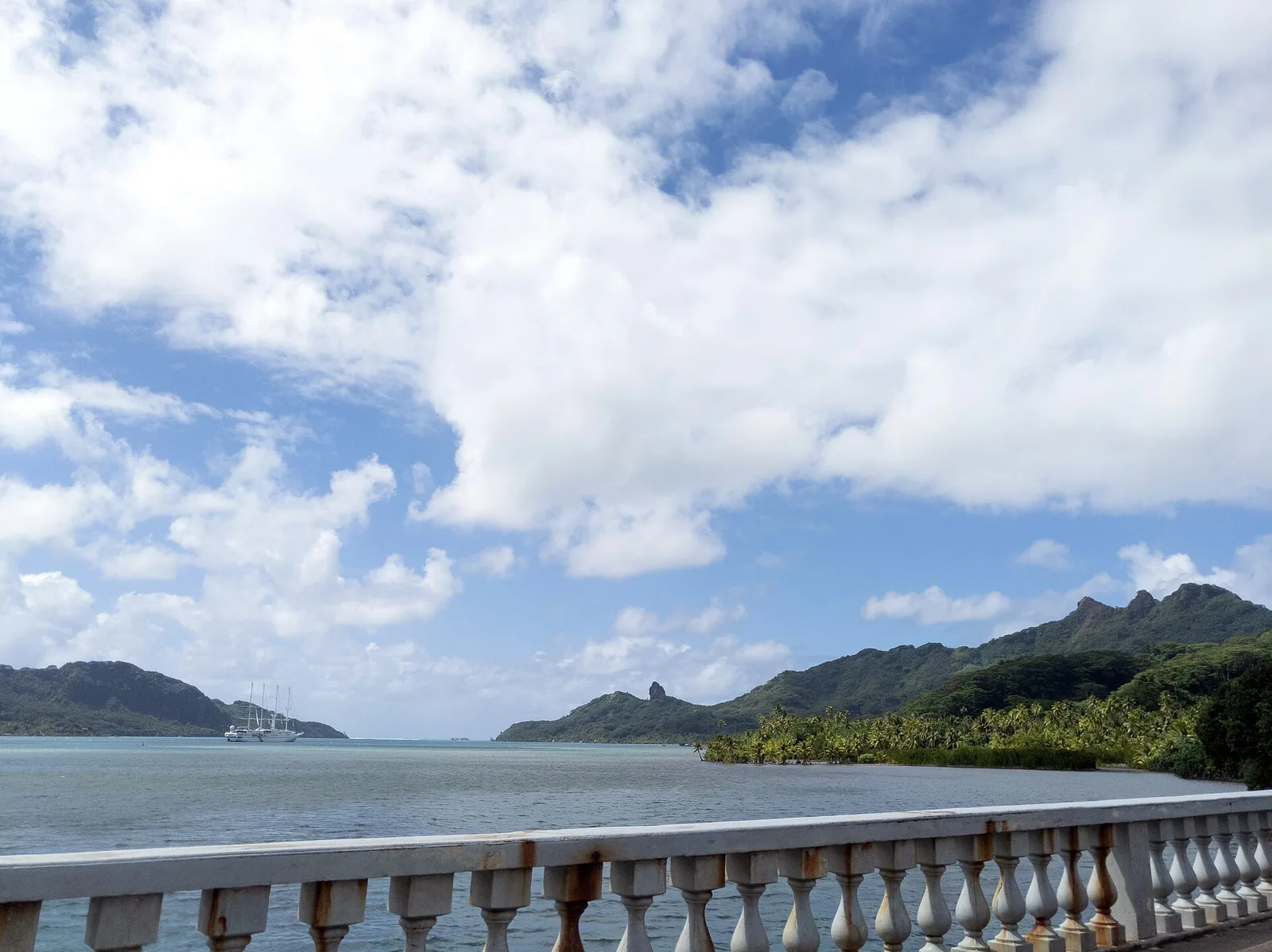 Lagoon and hills seen from a waterside terrace on Huahine