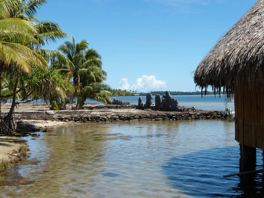 Thatched fare pote’e meeting house by the lagoon at Maeva, Huahine