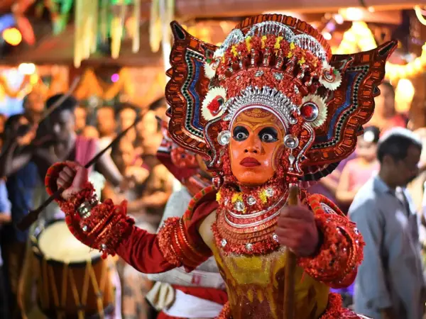 Theyyam performers in traditional attire perform at Muzhappilangad village, Kerala.