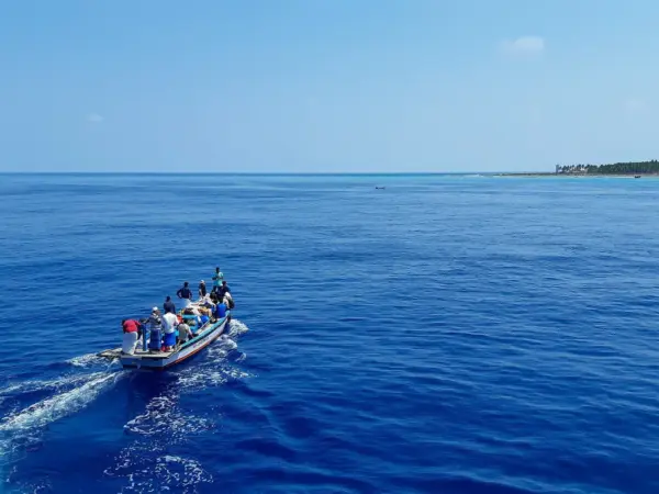 A small blue boat crossing the open sea in Lakshadweep