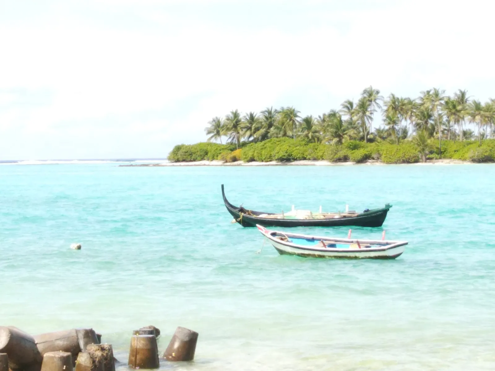Small boats moored in the lagoon off Kalpeni Island