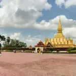 The golden Pha That Luang stupa in Vientiane with the statue of King Setthathirat in front
