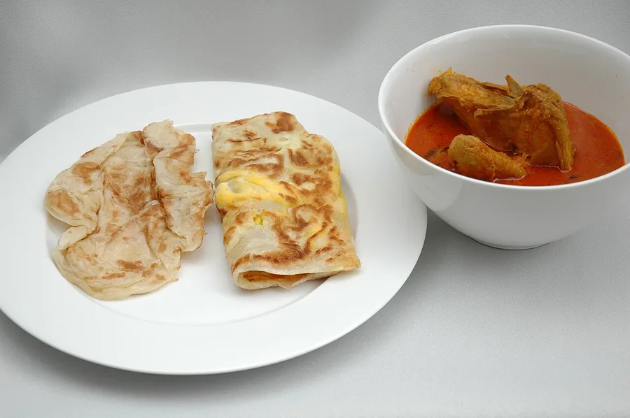 Roti canai, flaky flatbread served with curry
