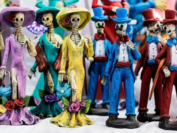 Colorful Catrina skeletons with floral hats, typical of Day of the Dead celebrations in Mexico