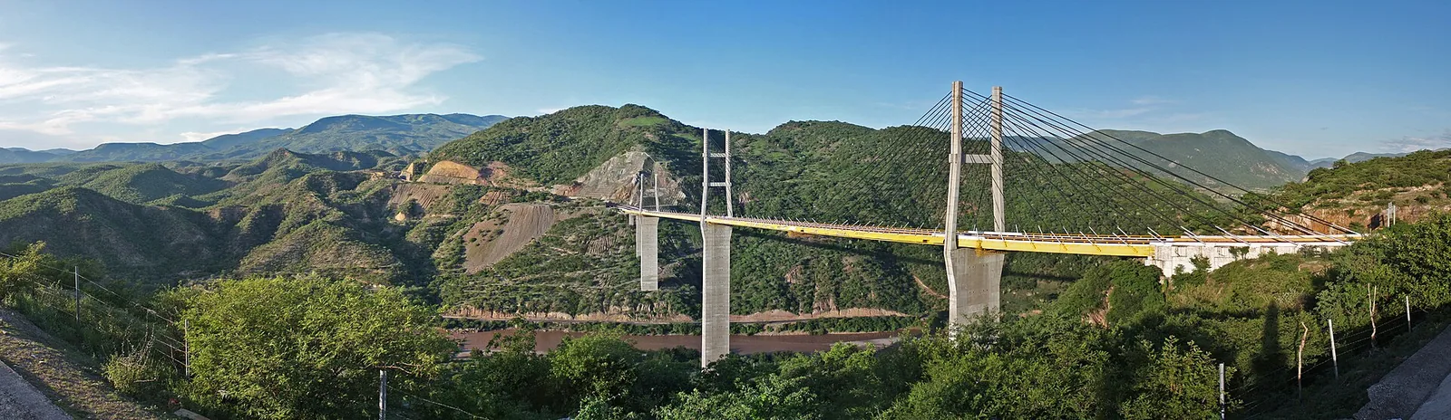Long steel Mezcala Bridge spanning a river on Highway 95D, seen from a distance