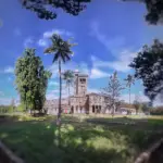 Historic university buildings with red brick facades and leafy courtyards at Savitribai Phule Pune University