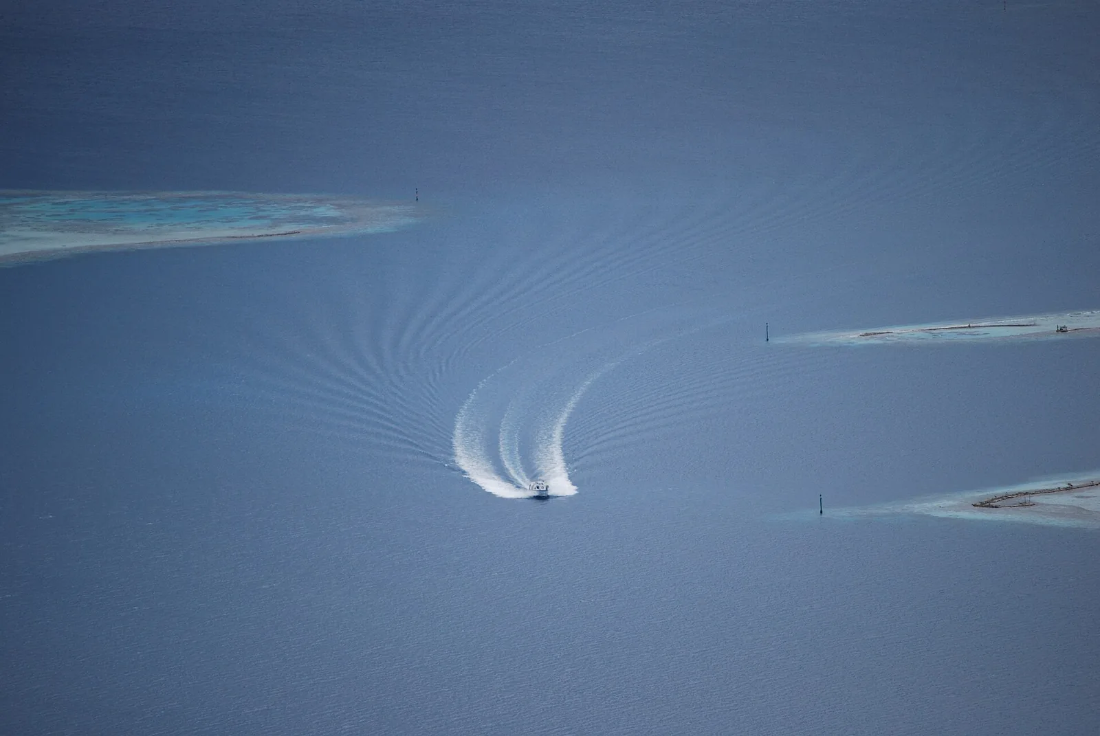 A boat crossing the lagoon off Raiatea
