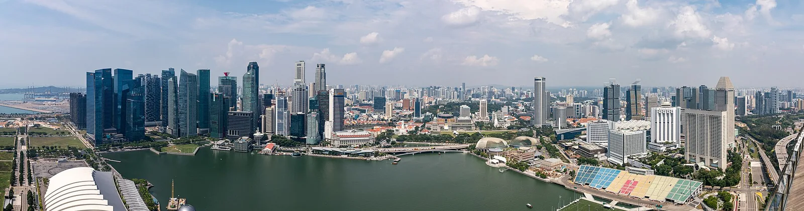 View from Marina Bay Sands SkyPark showing the skyline with the waterfront, hotel towers and gardens below