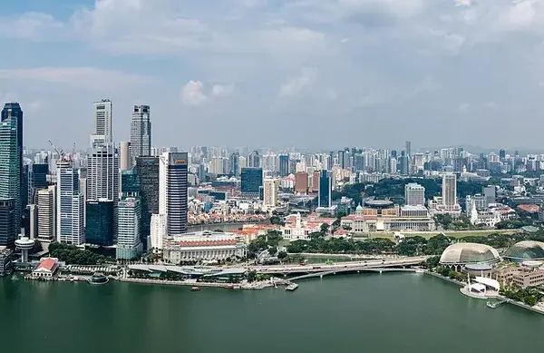 Panoramic shot from Marina Bay Sands SkyPark overlooking Marina Bay’s water, skyscrapers and the iconic hotel silhouette