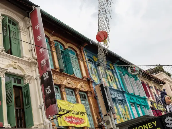 Pagoda Street in Chinatown lined with shophouses, colorful shop signs and bustling street life