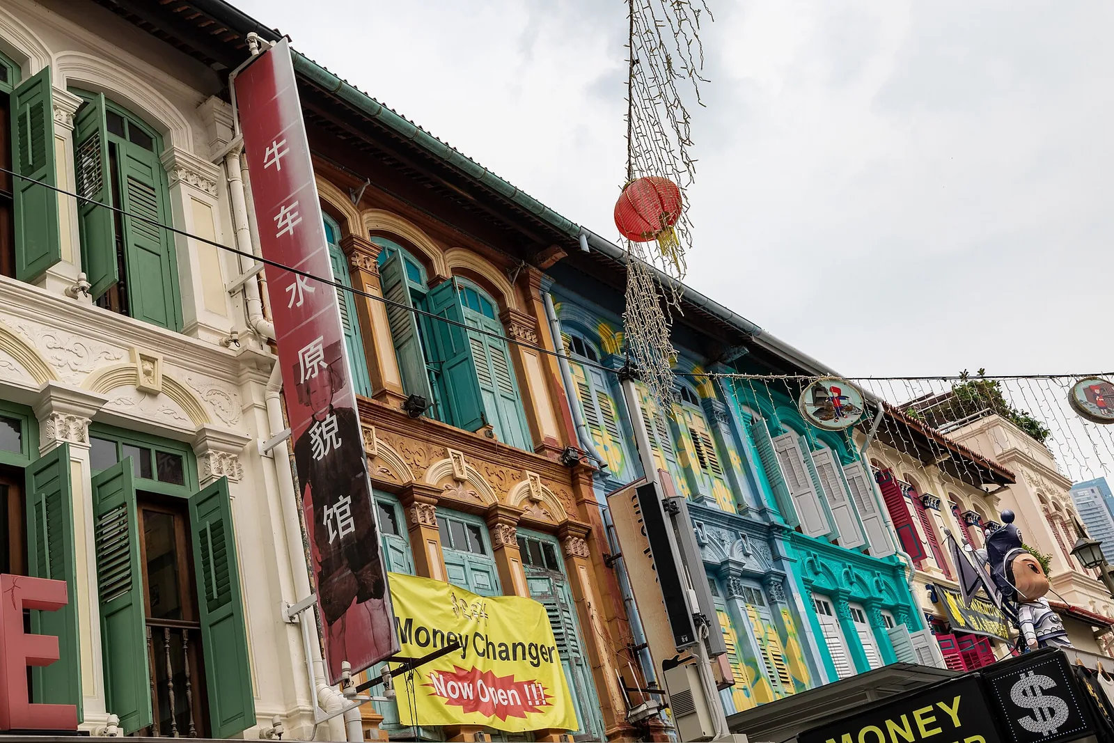 Pagoda Street in Chinatown lined with shophouses, colorful shop signs and bustling street life