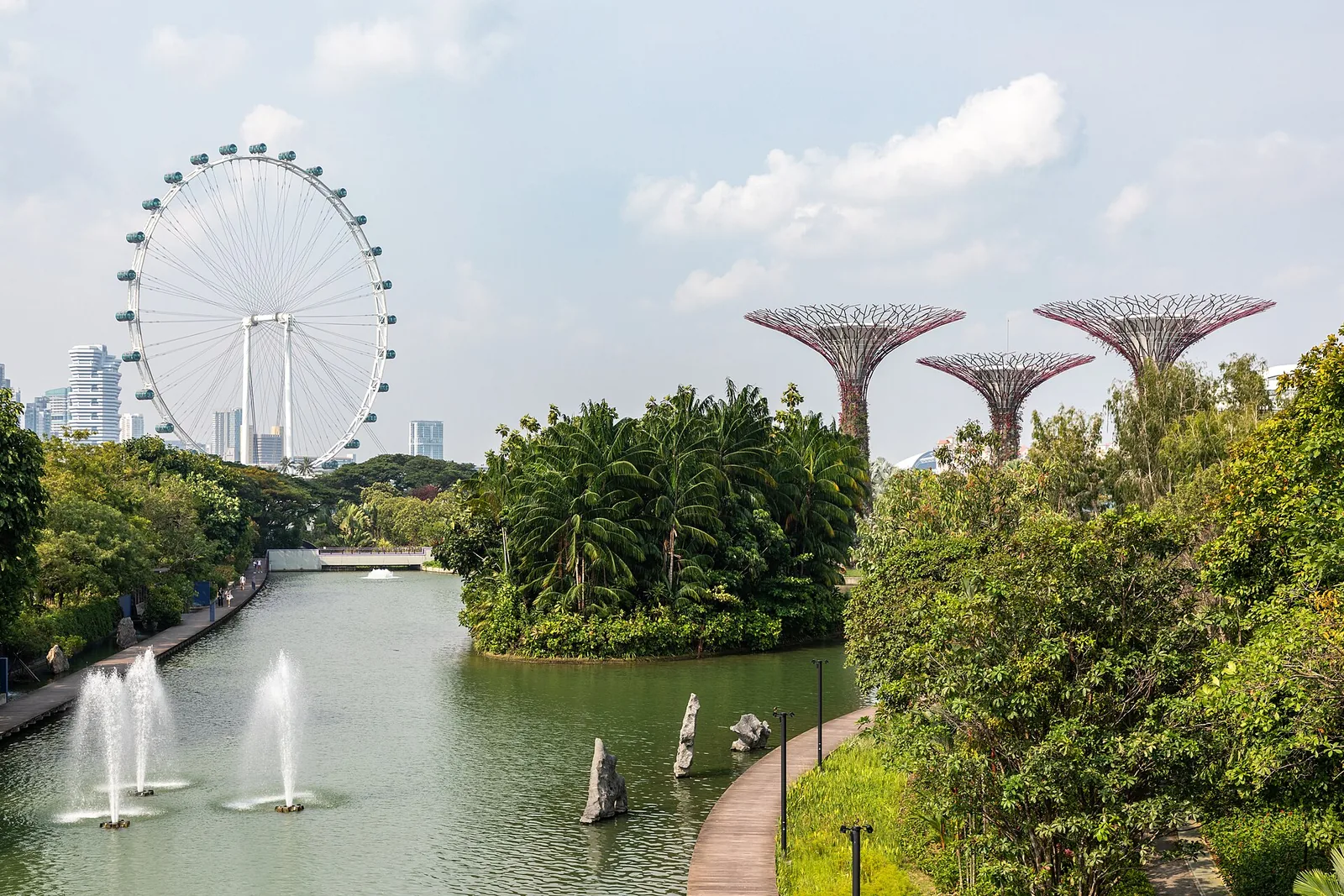 Gardens by the Bay displaying futuristic Supertree structures, sky‑filled walkways and lush garden terraces