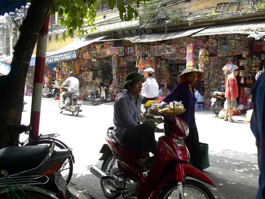 Shoppers and motorbikes on a street in Hanoi’s Old Quarter